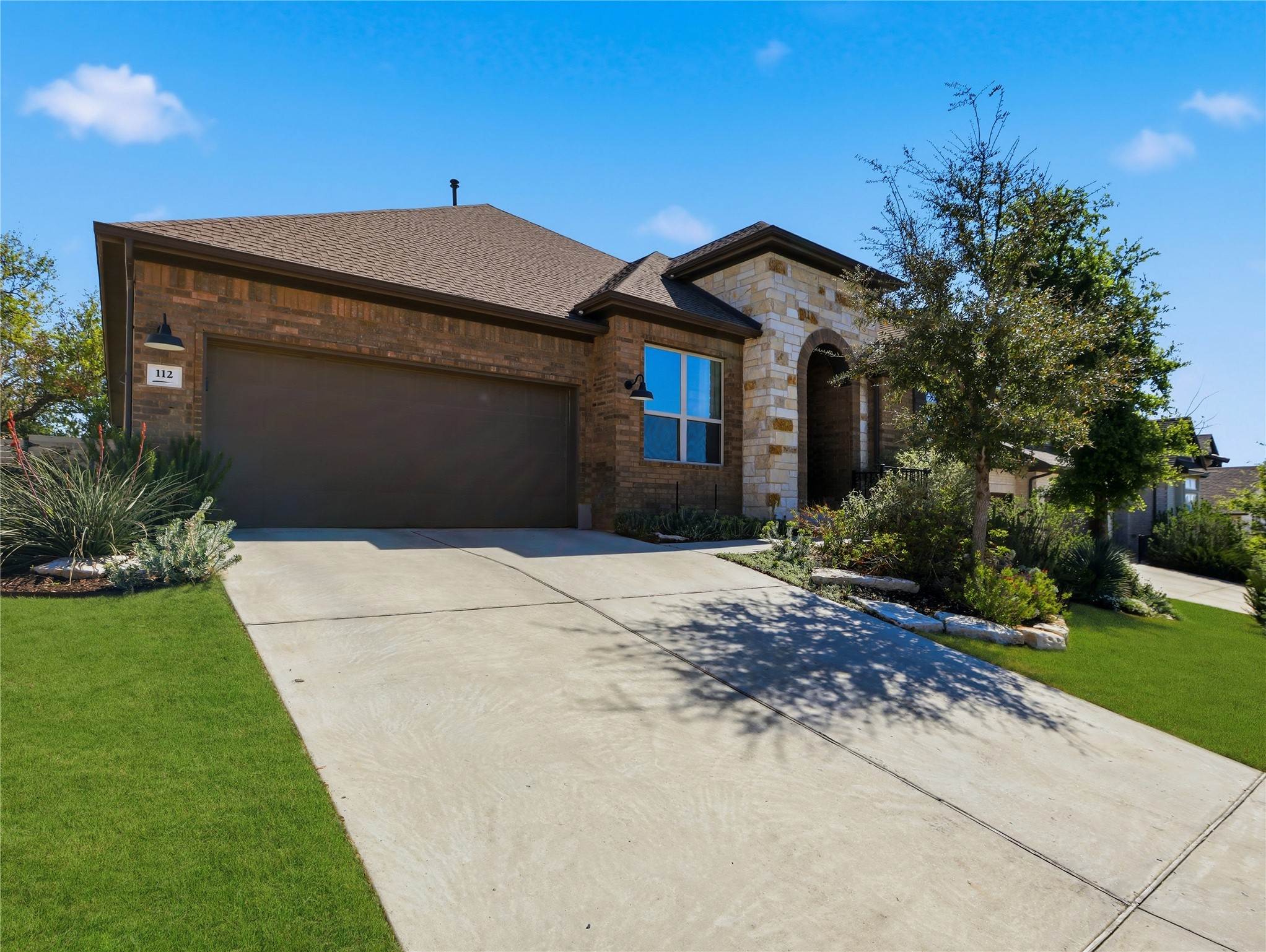 112 Mountain Lion Road Georgetown, TX 78628 - Photo 5 of 37 a front view of a house with a yard and garage
