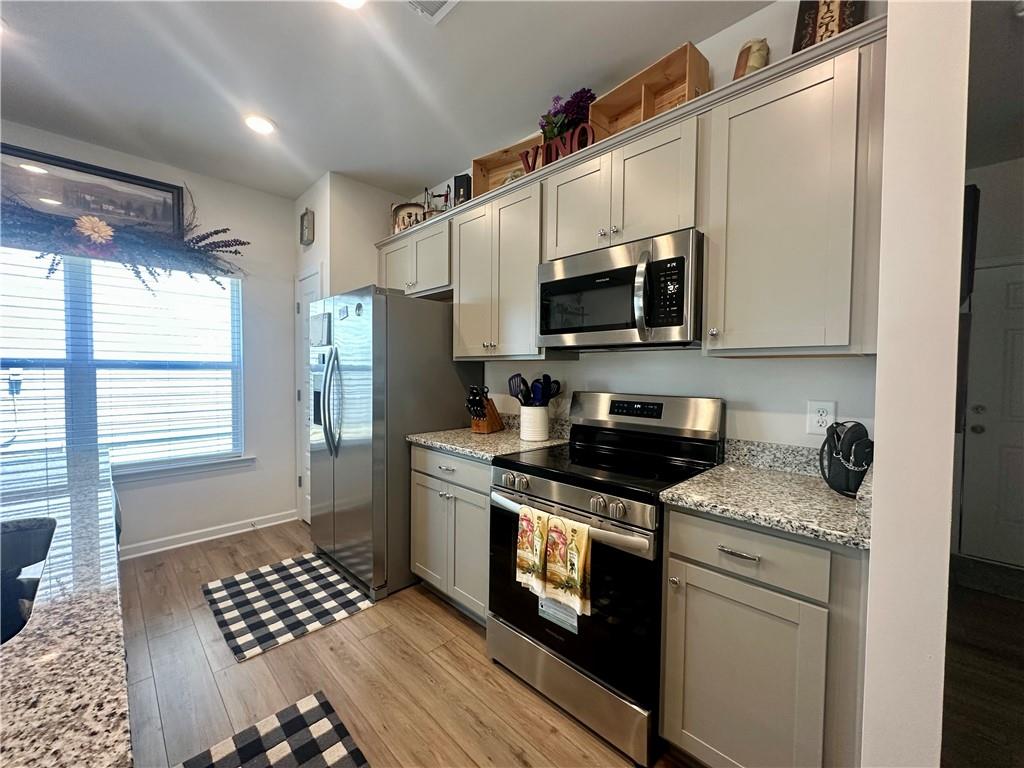 53 Bennett Way Rome, GA 30161 - Photo 34 of 42 a kitchen with stainless steel appliances a stove a sink and a microwave