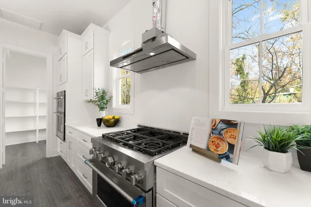 a view of a room with wooden floor and windows