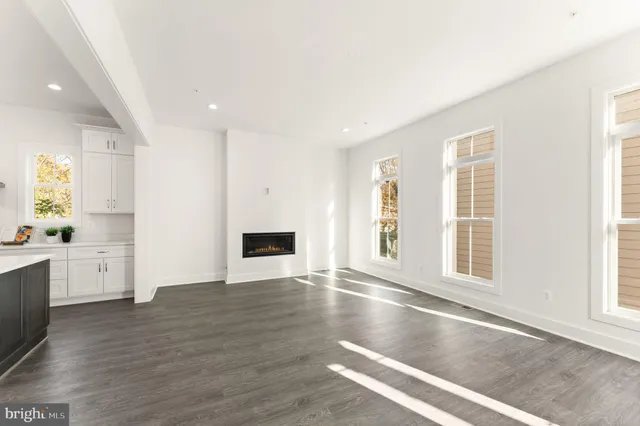 a view of a hallway with wooden floor and entryway