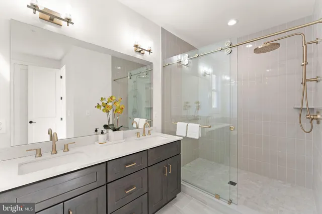 a bathroom with a shower and a mirror