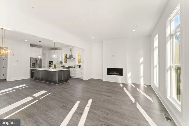 a large kitchen with granite countertop a white stove top oven and cabinets