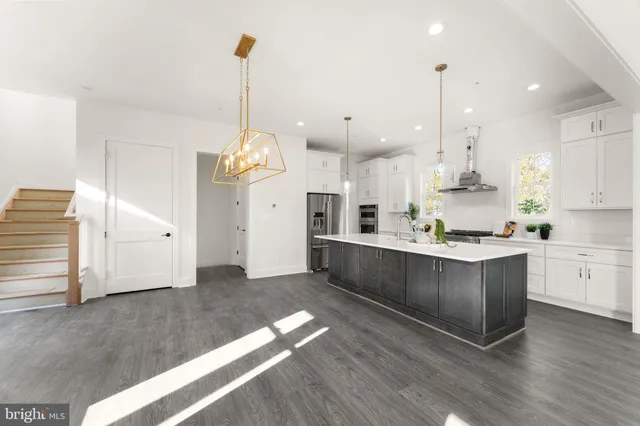 a large kitchen with cabinets and wooden floor