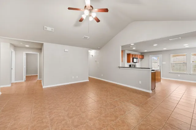 a view of a kitchen with a sink and a refrigerator