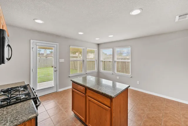 a kitchen with a sink and large window