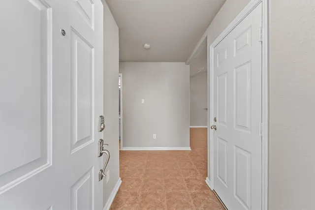 a view of a hallway with closet area