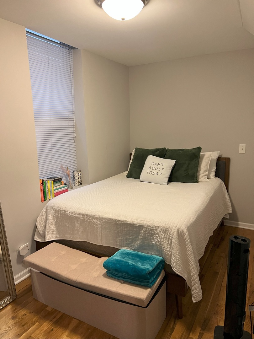 1532 West 18th Place, Unit 1F Chicago, IL 60608 - Photo 13 of 14 a bedroom with a bed and a mirror