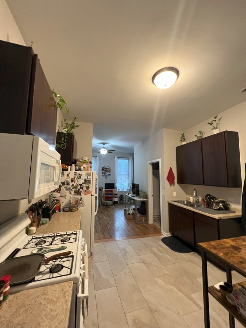 1532 West 18th Place, Unit 1F Chicago, IL 60608 - Photo 3 of 14 a living room with furniture and a flat screen tv