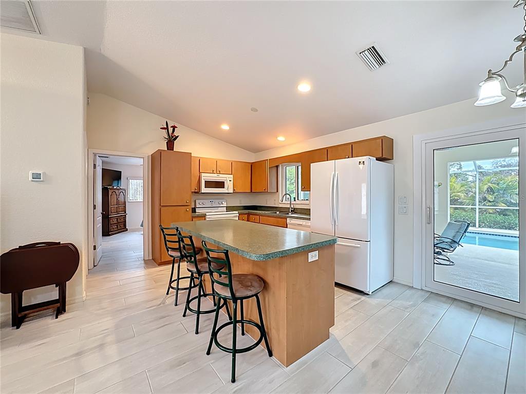 2500 Allegheny Lane North Port, FL 34286 - Photo 11 of 46 a kitchen with stainless steel appliances a refrigerator a table and chairs