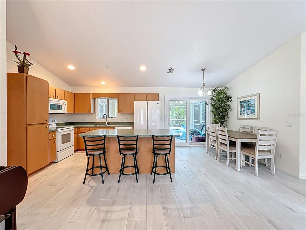 2500 Allegheny Lane North Port, FL 34286 - Photo 12 of 46 a view of a dining room with furniture and wooden floor