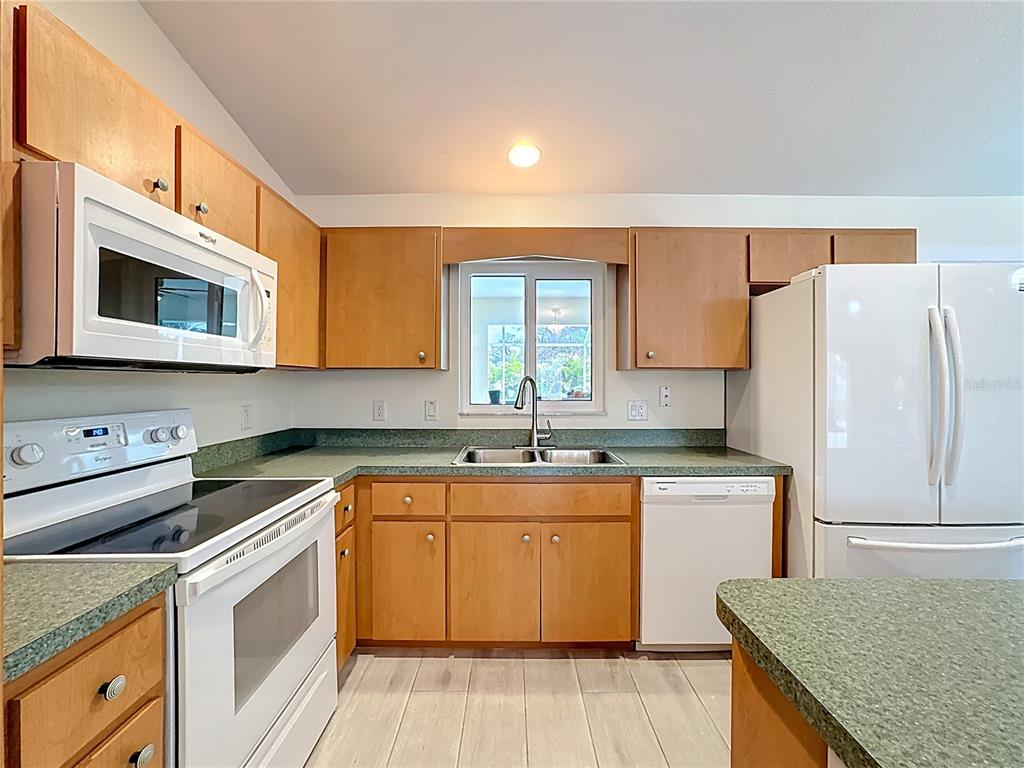 2500 Allegheny Lane North Port, FL 34286 - Photo 15 of 46 a kitchen with stainless steel appliances granite countertop a stove a sink dishwasher and a refrigerator