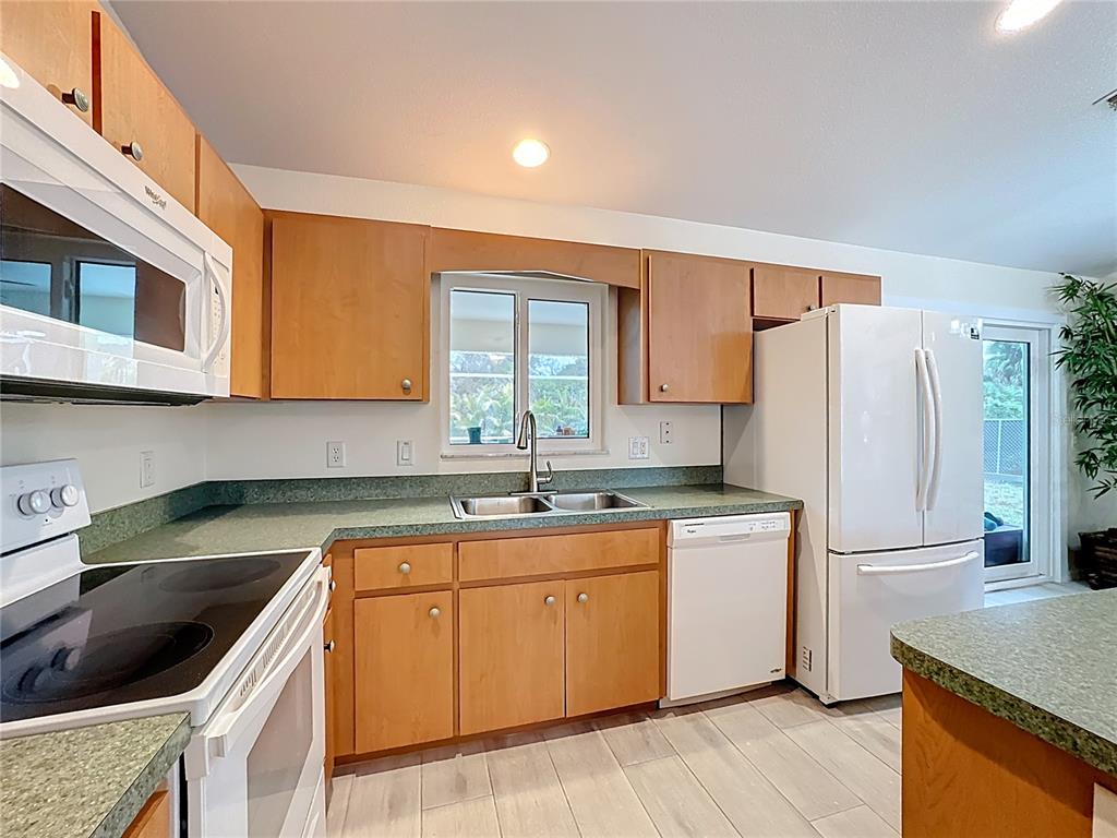 2500 Allegheny Lane North Port, FL 34286 - Photo 16 of 46 a kitchen with a sink stove and refrigerator