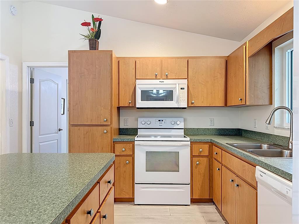 2500 Allegheny Lane North Port, FL 34286 - Photo 18 of 46 a kitchen with stainless steel appliances granite countertop a sink stove and refrigerator