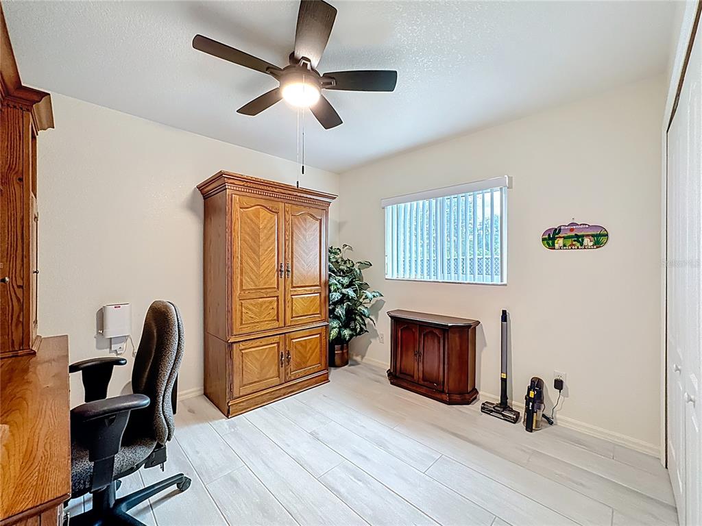 2500 Allegheny Lane North Port, FL 34286 - Photo 21 of 46 a living room with furniture a fireplace and a window