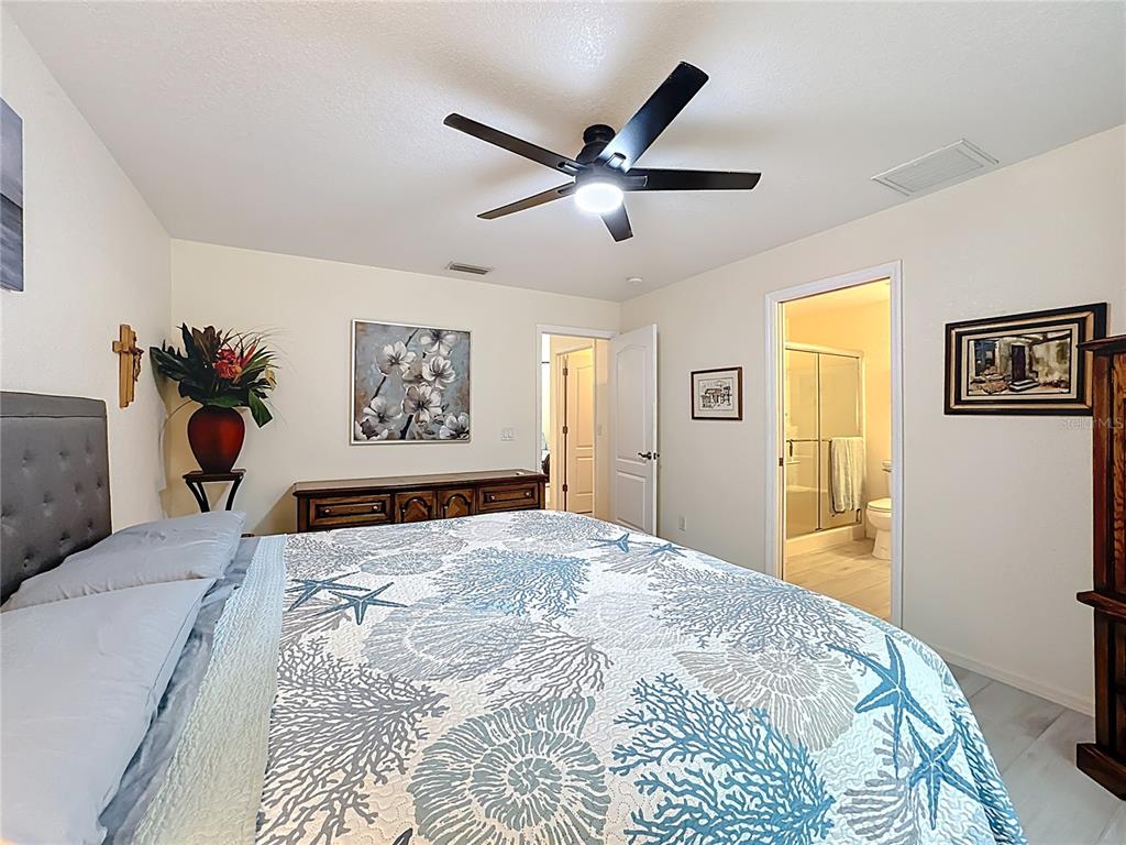 2500 Allegheny Lane North Port, FL 34286 - Photo 28 of 46 a bedroom with a large bed and a chandelier