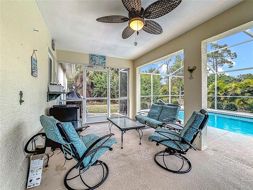 2500 Allegheny Lane North Port, FL 34286 - Photo 32 of 46 a living room with furniture and floor to ceiling windows