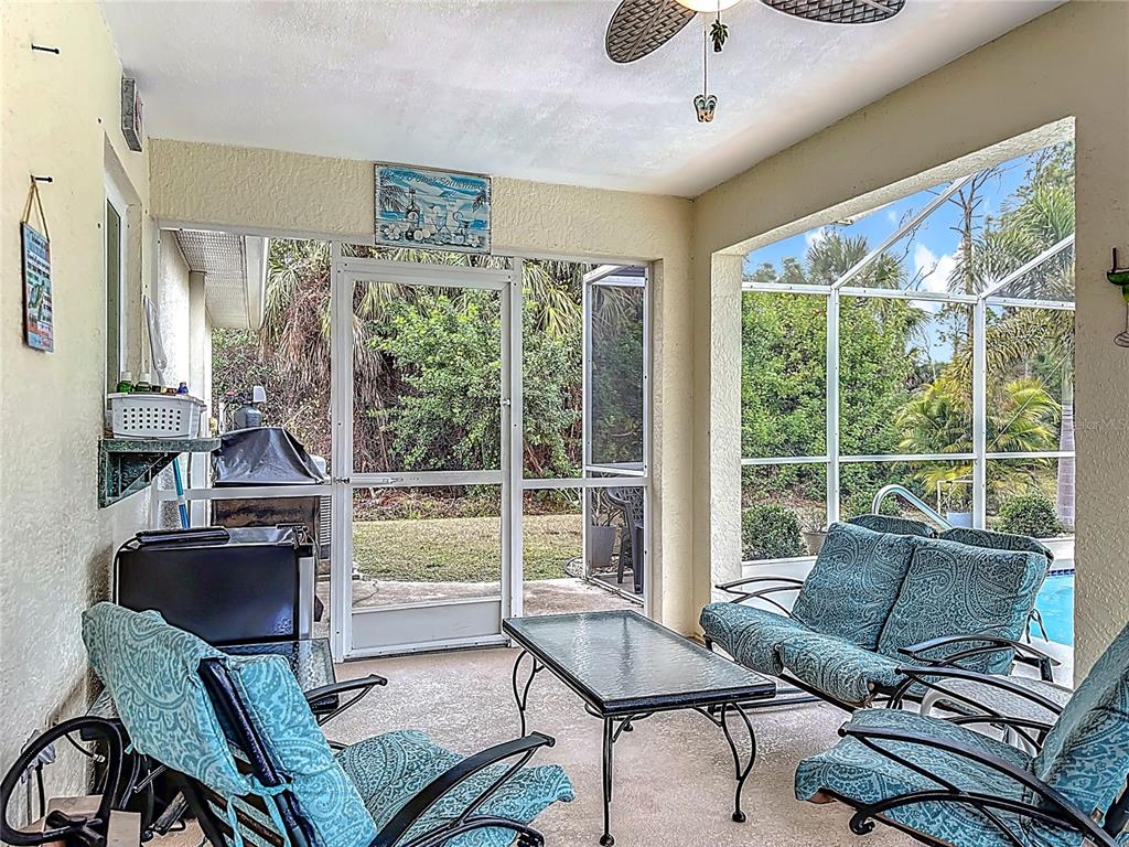 2500 Allegheny Lane North Port, FL 34286 - Photo 33 of 46 a living room with furniture and a floor to ceiling window
