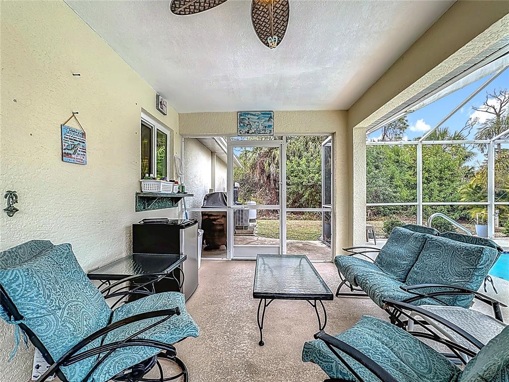2500 Allegheny Lane North Port, FL 34286 - Photo 34 of 46 a living room with furniture and a floor to ceiling window