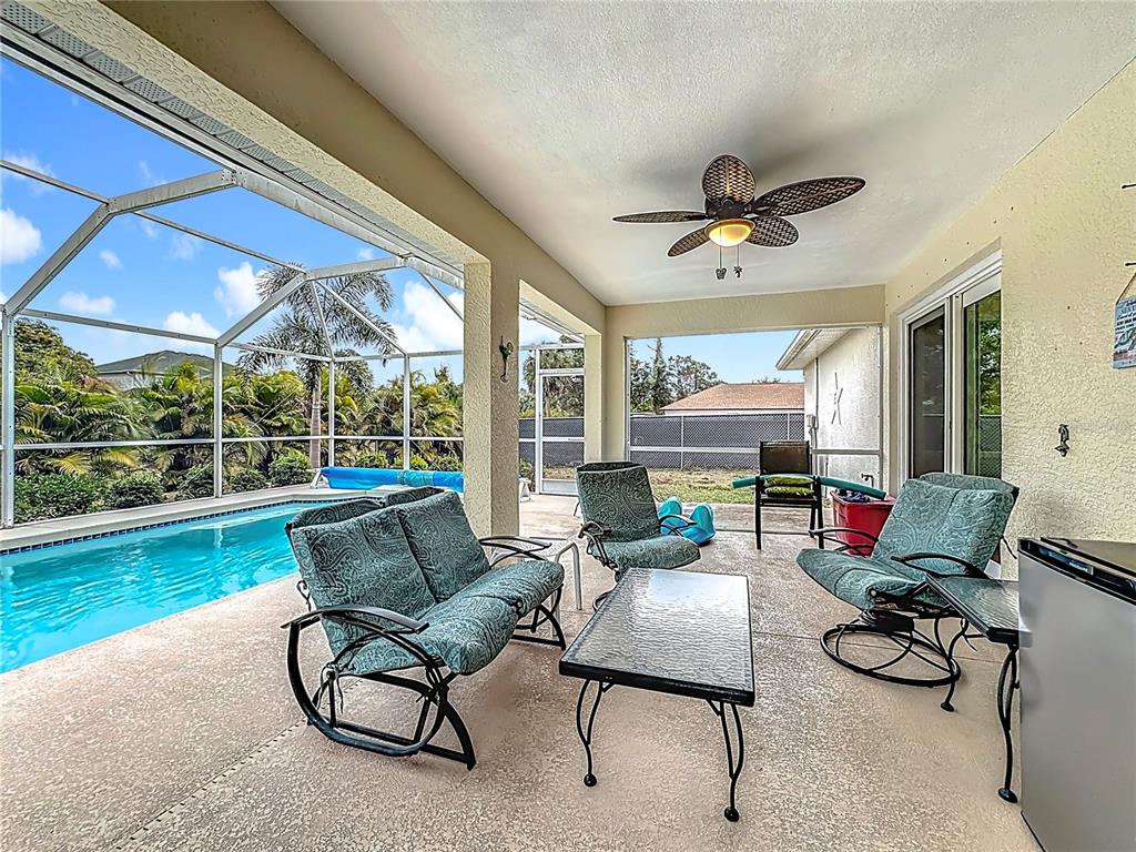 2500 Allegheny Lane North Port, FL 34286 - Photo 35 of 46 a living room with furniture and a floor to ceiling window