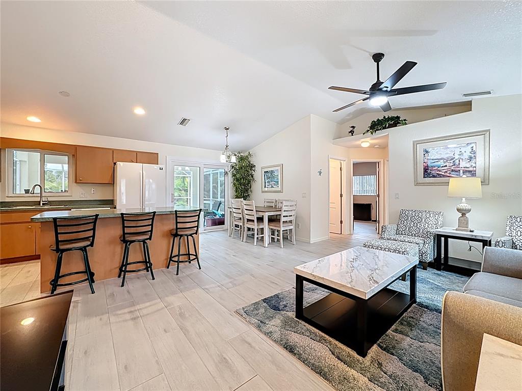 2500 Allegheny Lane North Port, FL 34286 - Photo 4 of 46 a living room with furniture a rug kitchen view and a table
