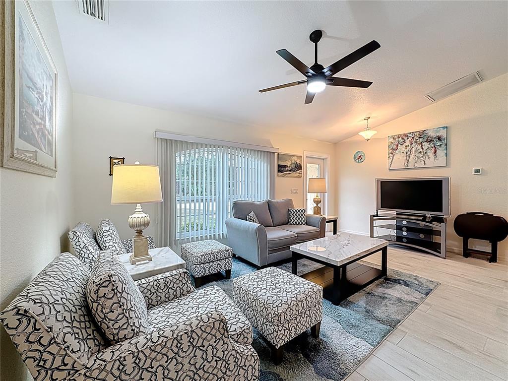 2500 Allegheny Lane North Port, FL 34286 - Photo 8 of 46 a living room with furniture a flat screen tv and a window