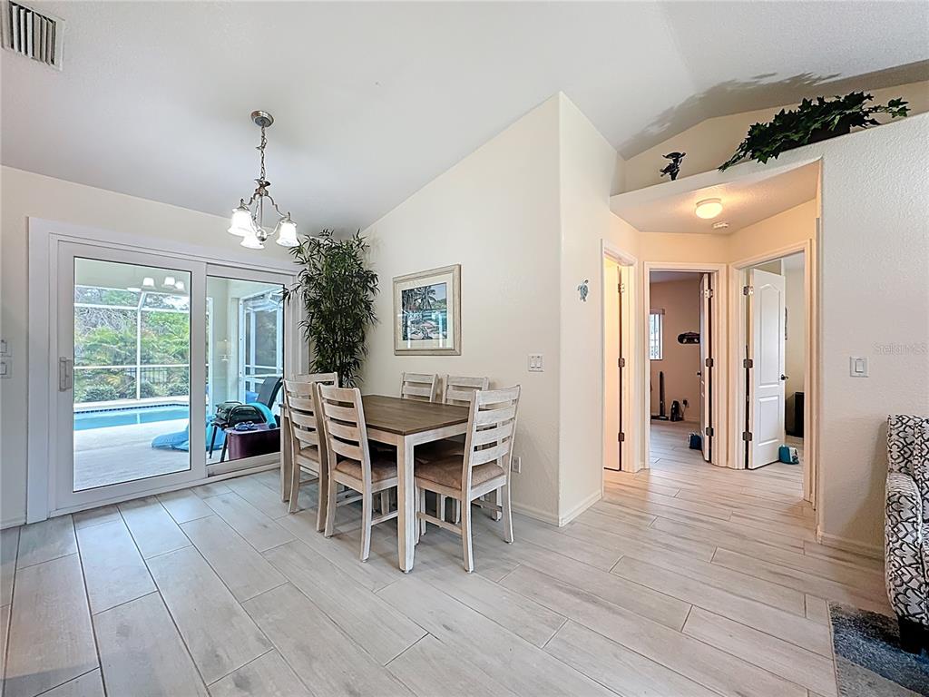 2500 Allegheny Lane North Port, FL 34286 - Photo 9 of 46 a dining room with furniture window and wooden floor