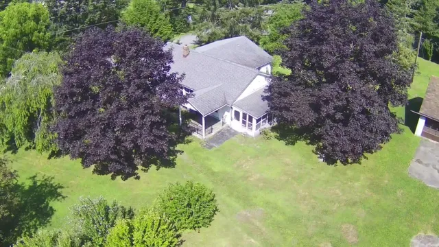a aerial view of house with yard and outdoor seating