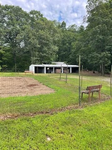 a view of a house with a backyard