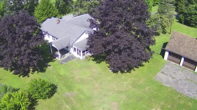 an aerial view of a house with garden space and street view