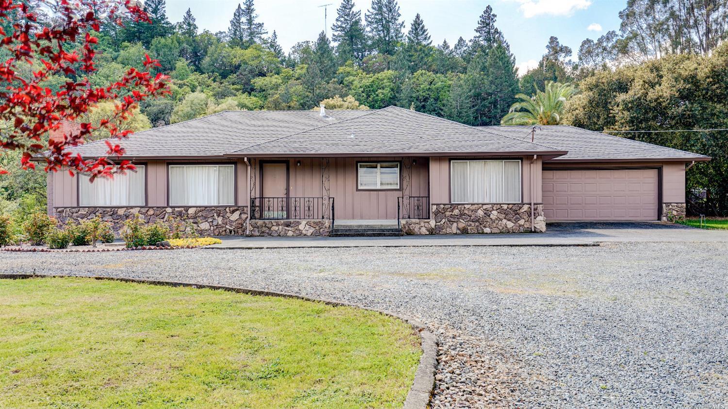 27377 Dutcher Creek Road Cloverdale, CA 95425 - Photo 1 of 1 a front view of a house with a yard and seating area