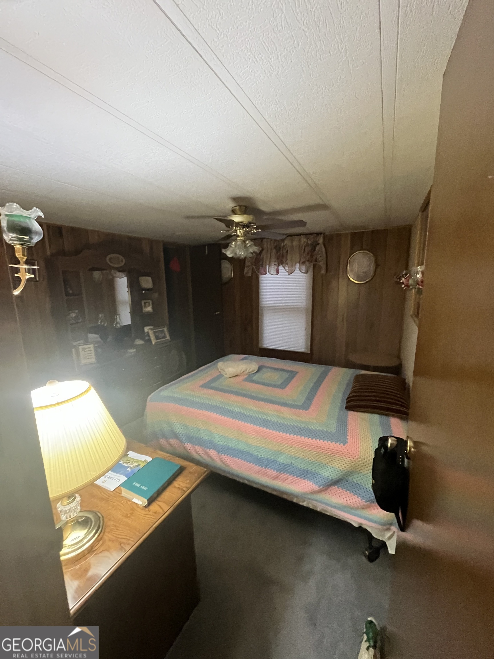 451 Weldon Lake Road Milner, GA 30257 - Photo 11 of 13 a bedroom with bed and window