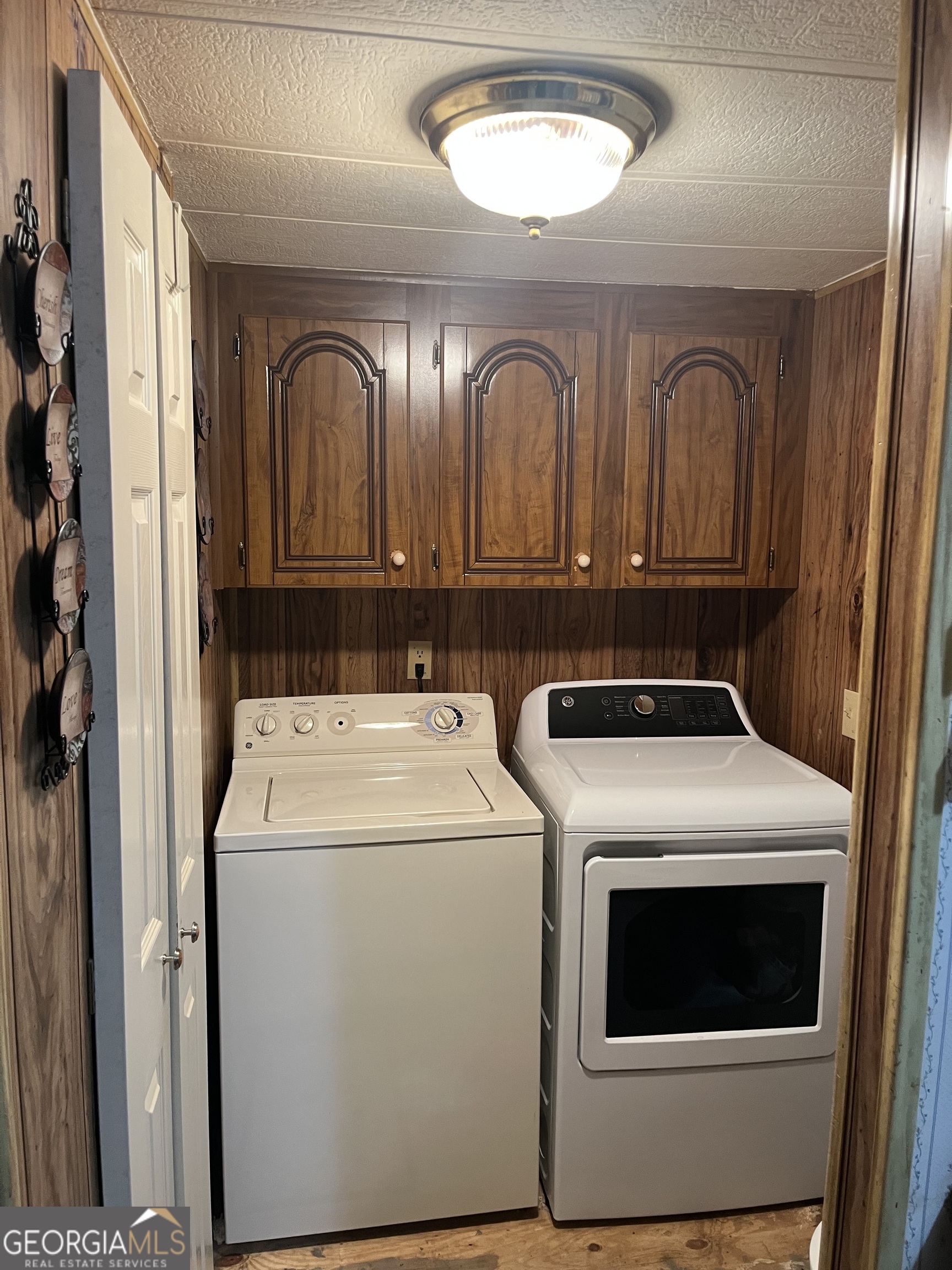451 Weldon Lake Road Milner, GA 30257 - Photo 7 of 13 a view of a storage and utility room with washer and dryer
