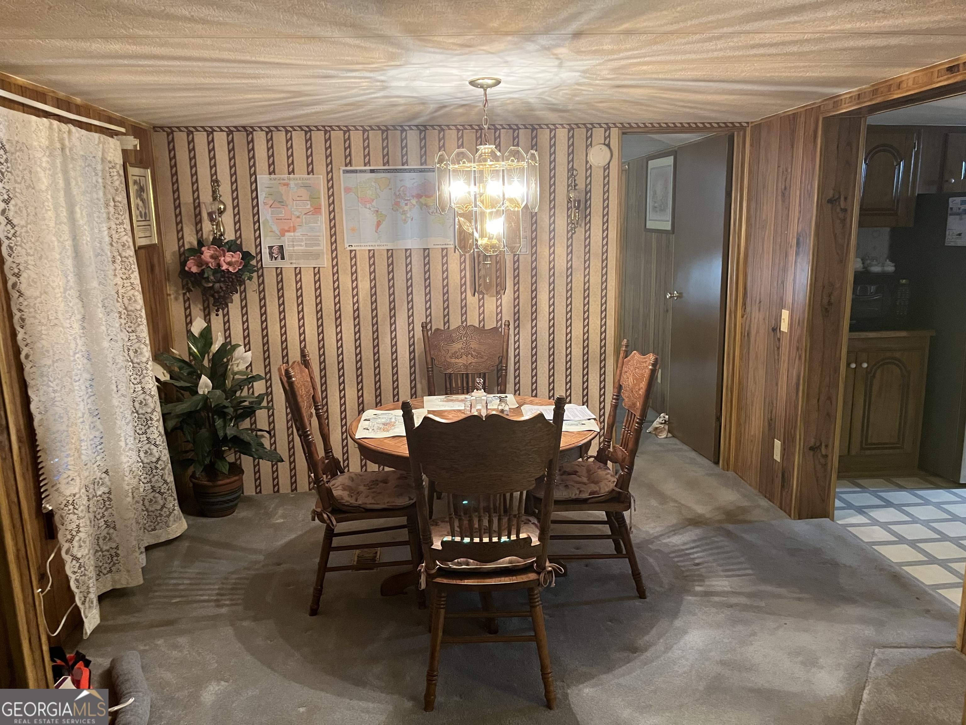 451 Weldon Lake Road Milner, GA 30257 - Photo 10 of 13 a view of a dining room with furniture and a chandelier