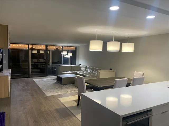 a large white kitchen with a large window