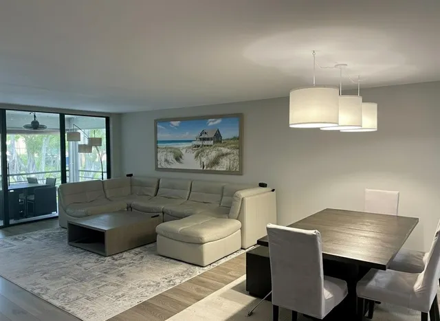 a living room with furniture and a lamp