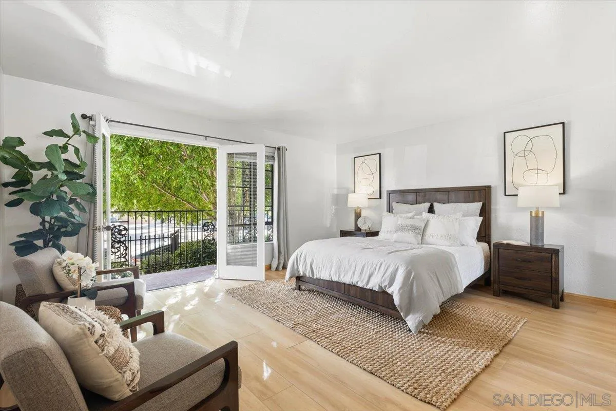 2630 Pirineos Way, Unit 5 Carlsbad, CA 92009 - Photo 15 of 48 a spacious bedroom with a bed and a couch next to a window