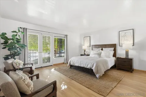 a spacious bedroom with a bed and a couch next to a window