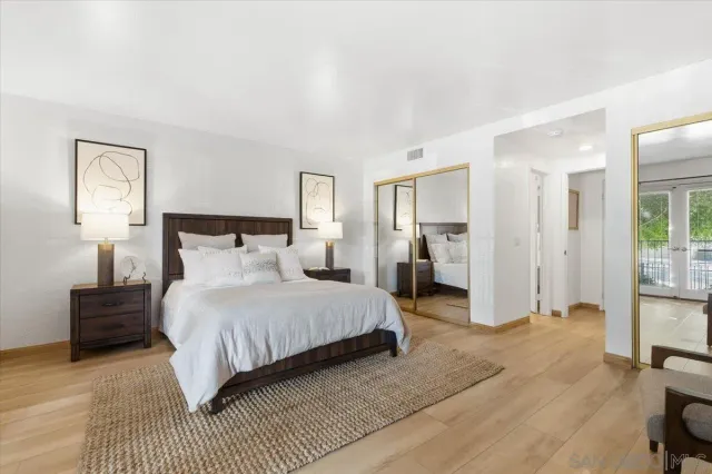 a bedroom with a bed and a lamp