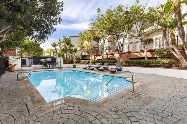 a view of swimming pool with outdoor seating and plants