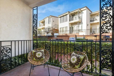 a view of a balcony with chair and iron fence