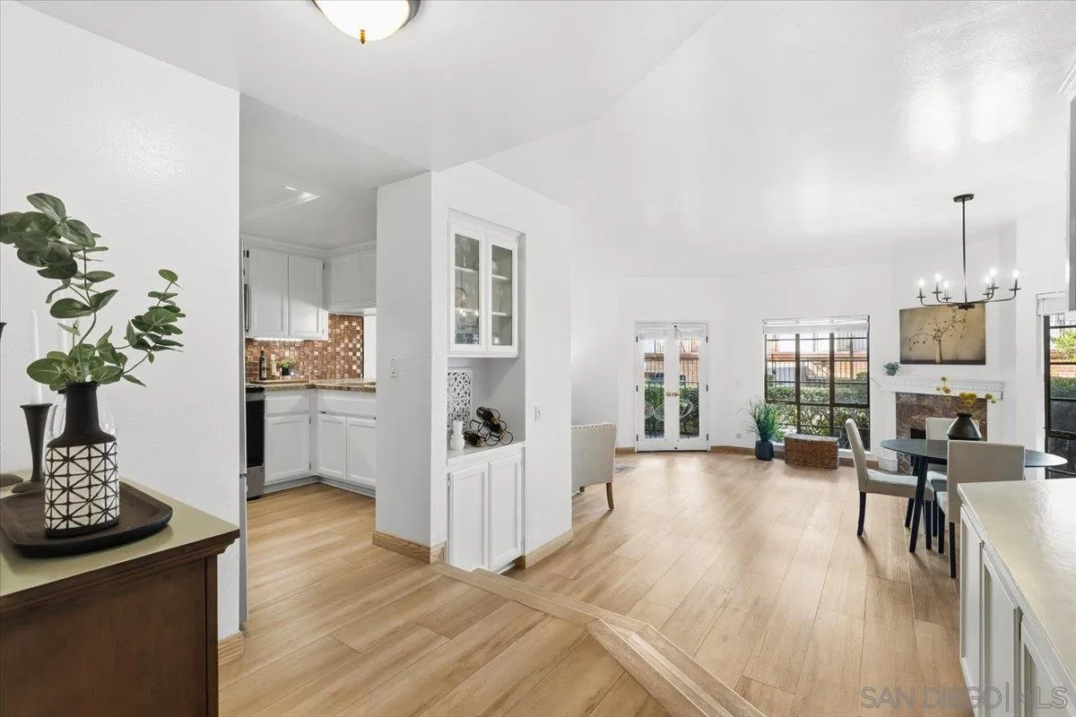 2630 Pirineos Way, Unit 5 Carlsbad, CA 92009 - Photo 3 of 48 a view of a living room and kitchen with furniture