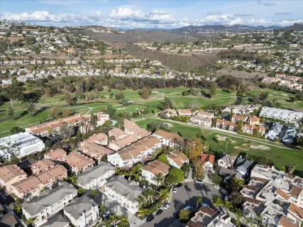 an aerial view of lake and residential houses with outdoor space