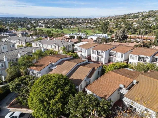 an aerial view of residential houses with city view