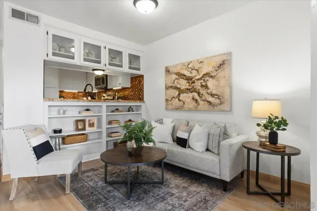 a living room with furniture and painting on the wall