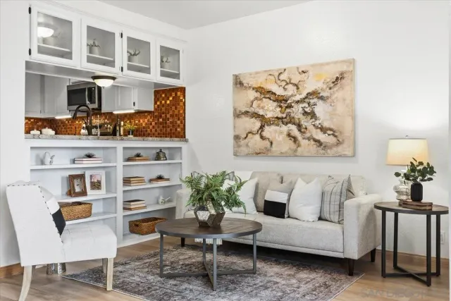 a living room with furniture cabinets and a potted plant