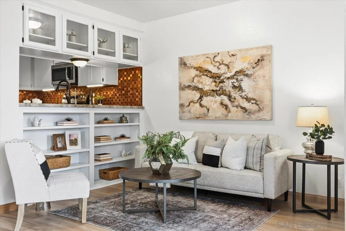2630 Pirineos Way, Unit 5 Carlsbad, CA 92009 - Photo 7 of 48 a living room with furniture cabinets and a potted plant