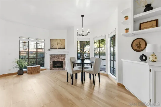 a view of a livingroom with furniture fireplace and wooden floor