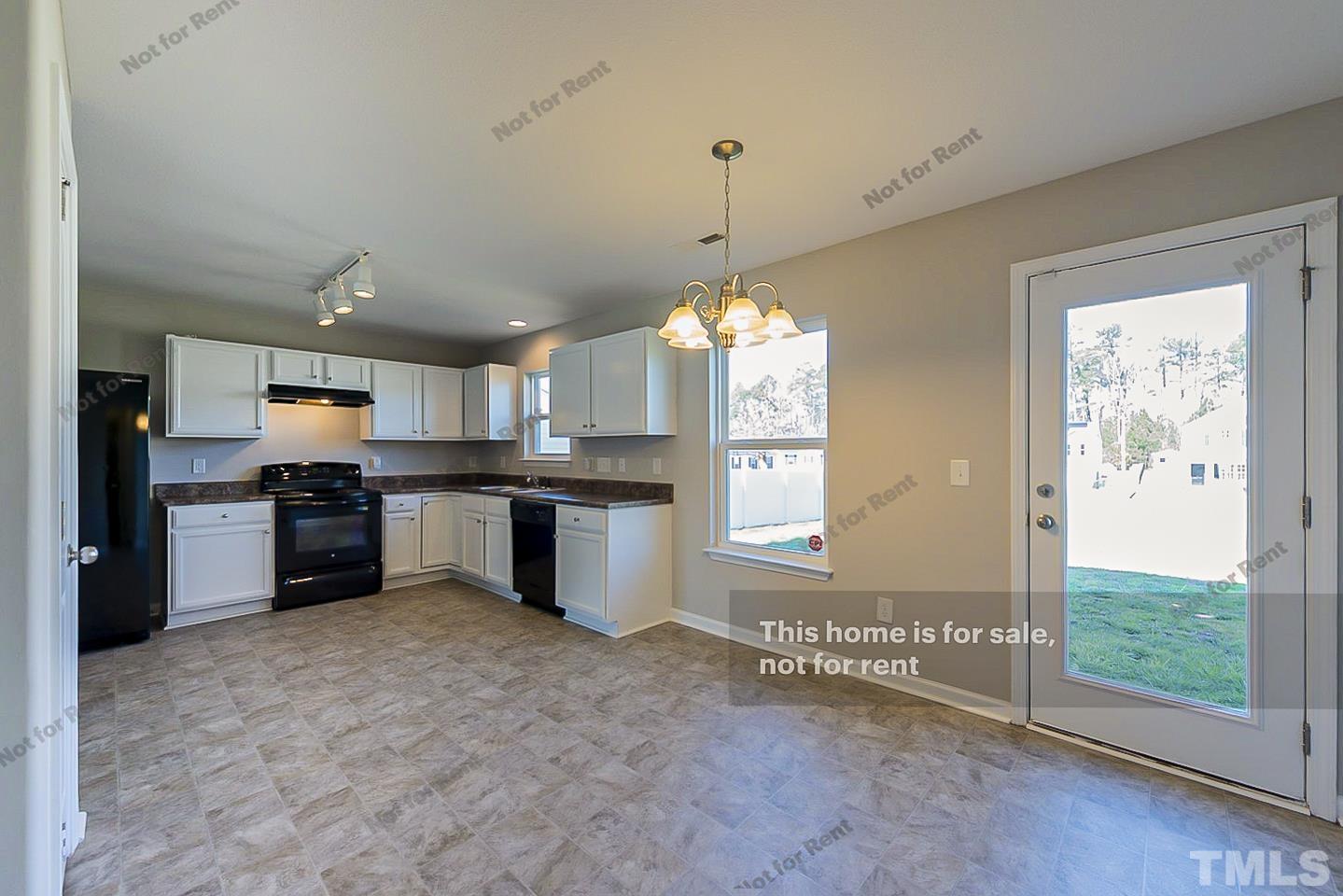 1908 Buffalo Way Durham, NC 27704 - Photo 12 of 26 a open kitchen with kitchen island granite countertop a refrigerator and a stove