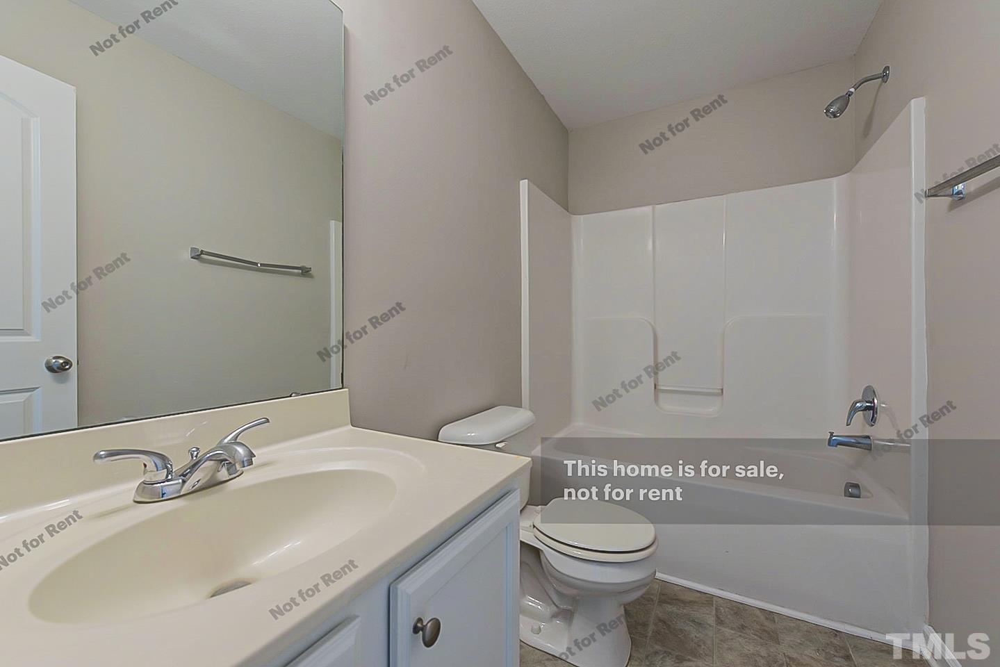 1908 Buffalo Way Durham, NC 27704 - Photo 23 of 26 a bathroom with a sink a toilet and shower