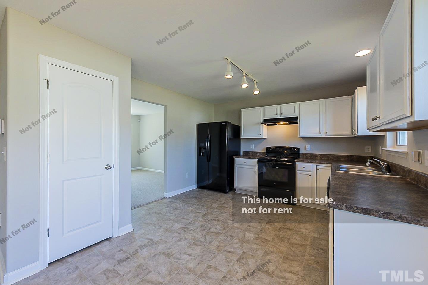 1908 Buffalo Way Durham, NC 27704 - Photo 6 of 26 a kitchen with a refrigerator and a stove top oven